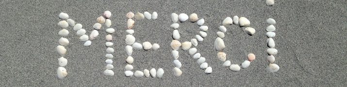 Merci écrit dans le sable